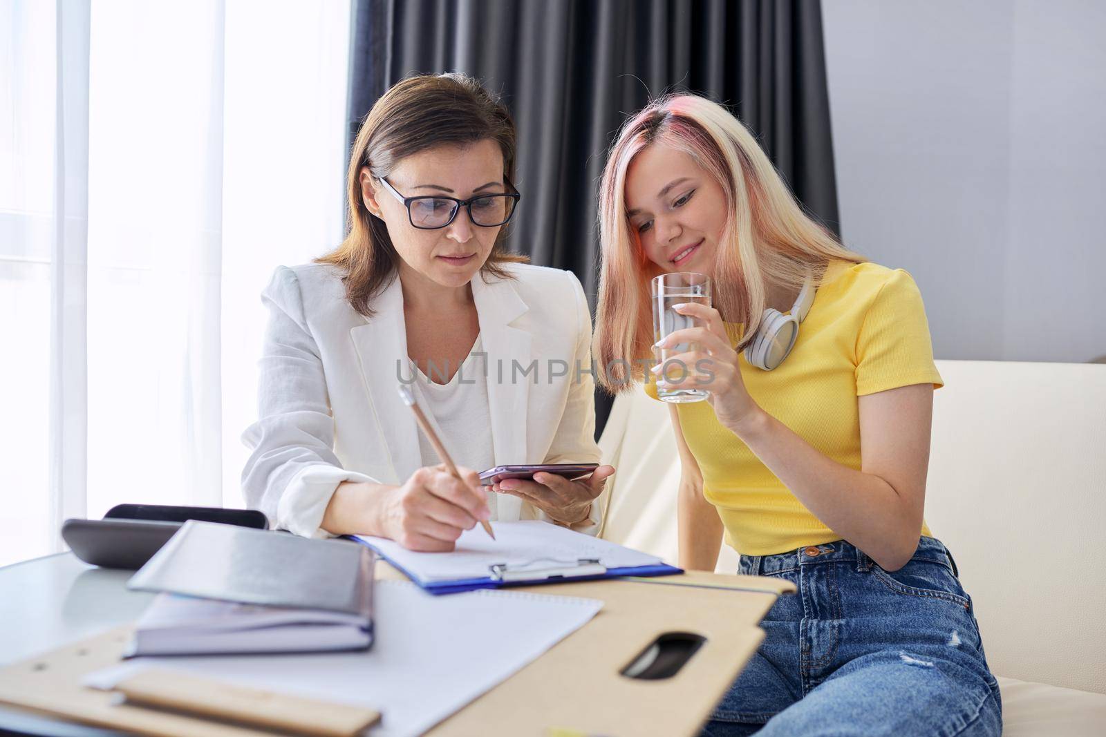 Teen girl talking to professional psychologist, individual therapy session for teenage with doctor. Difficulties of adolescence, mental health, social life of teenage