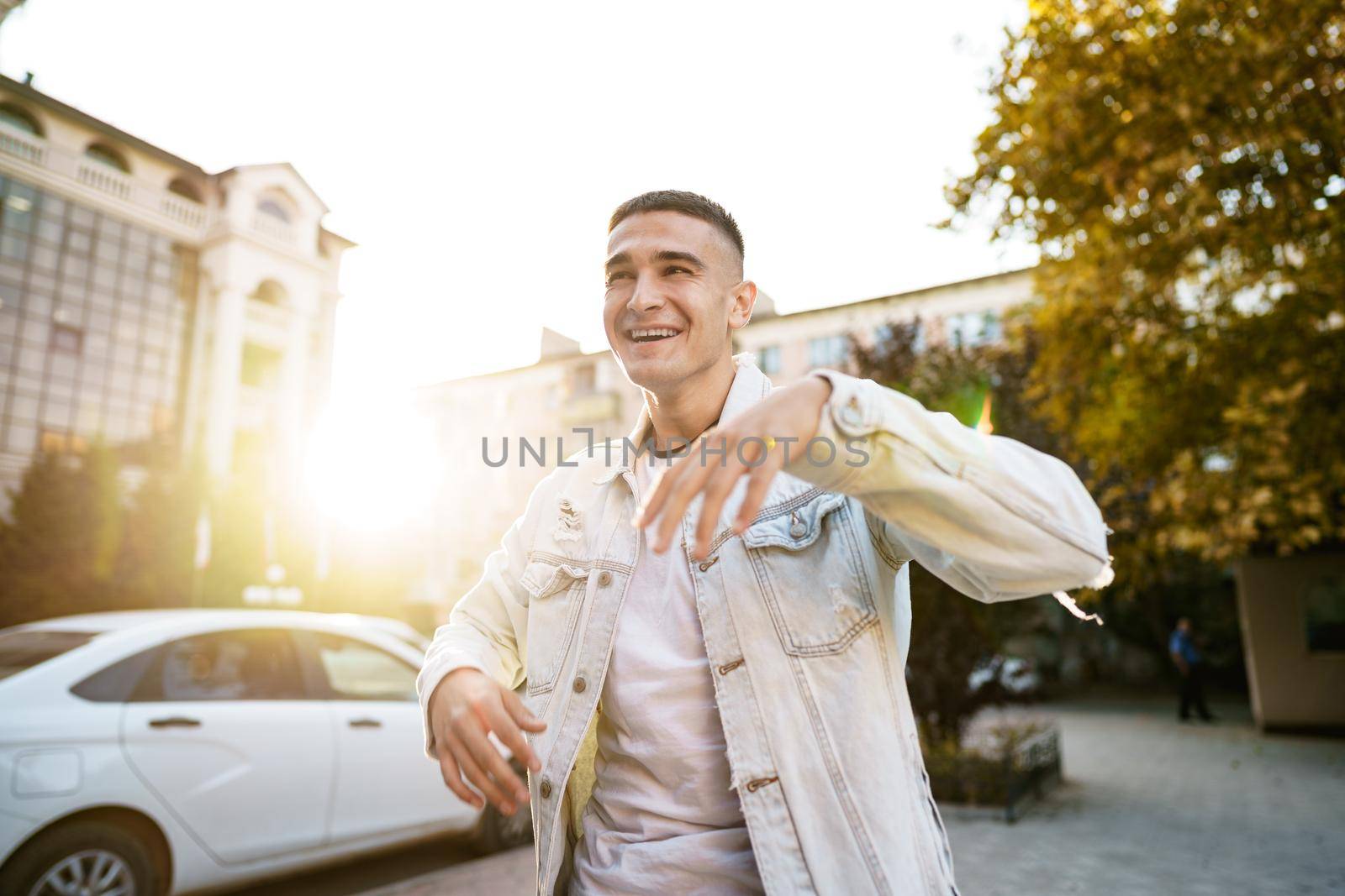 Portrait of handsome young casual man walking on the city street