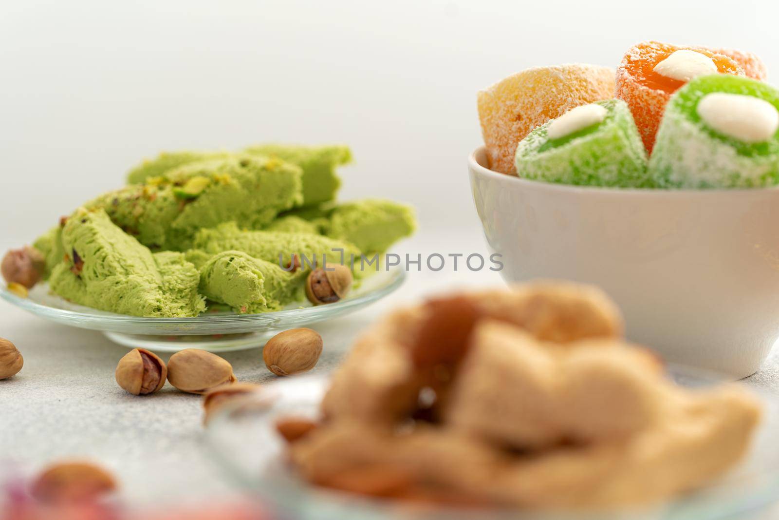 Close up photo of colorful Turkish halva sweets on gray surface