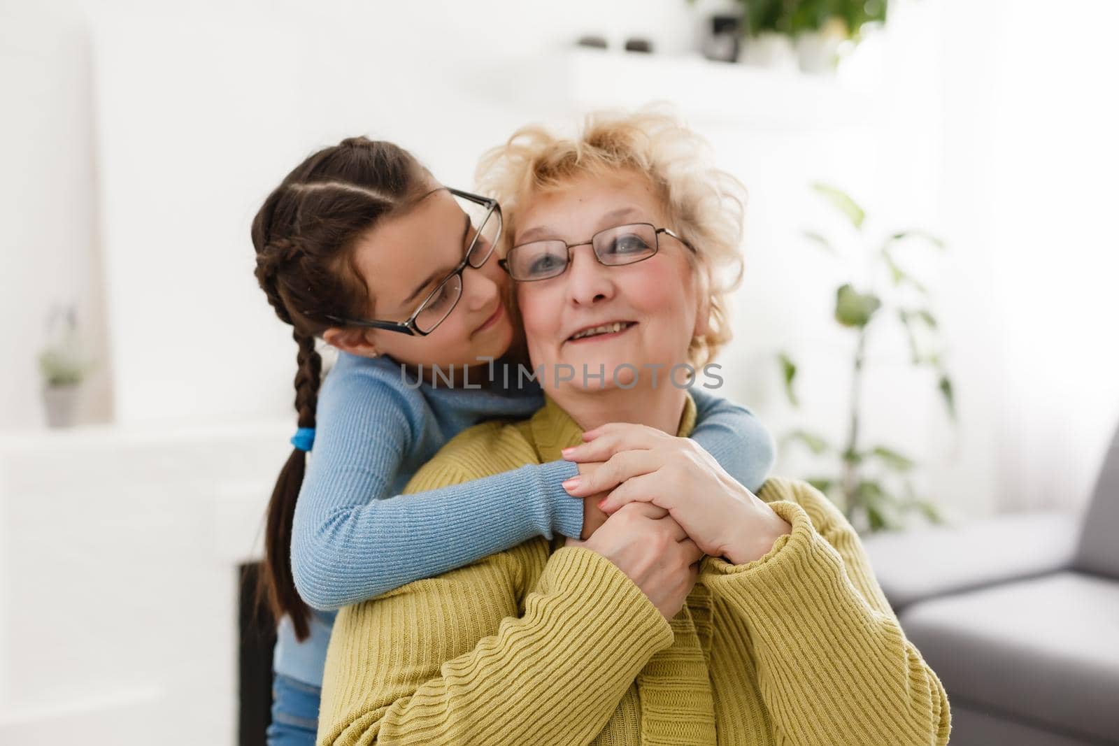 Grandmother and granddaughter portrait, embraced