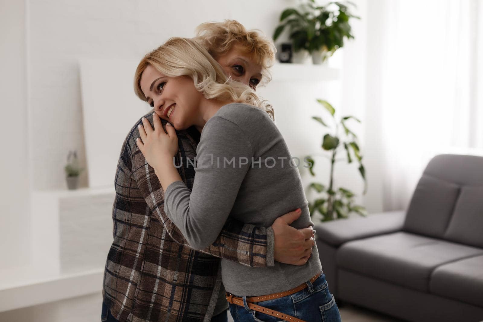 happy senior mother and adult daughter closeup portrait at home