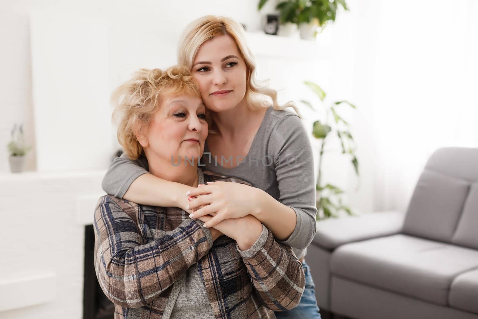 happy senior mother and adult daughter closeup portrait at home