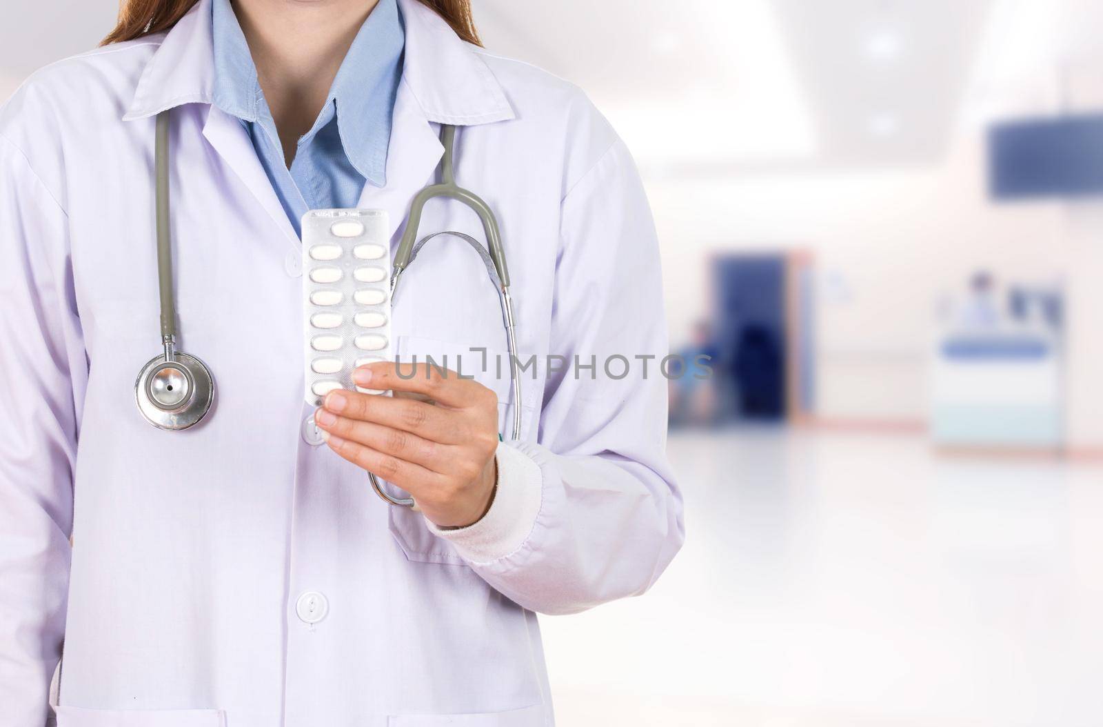 female doctor holding with pills in hospital  by geargodz