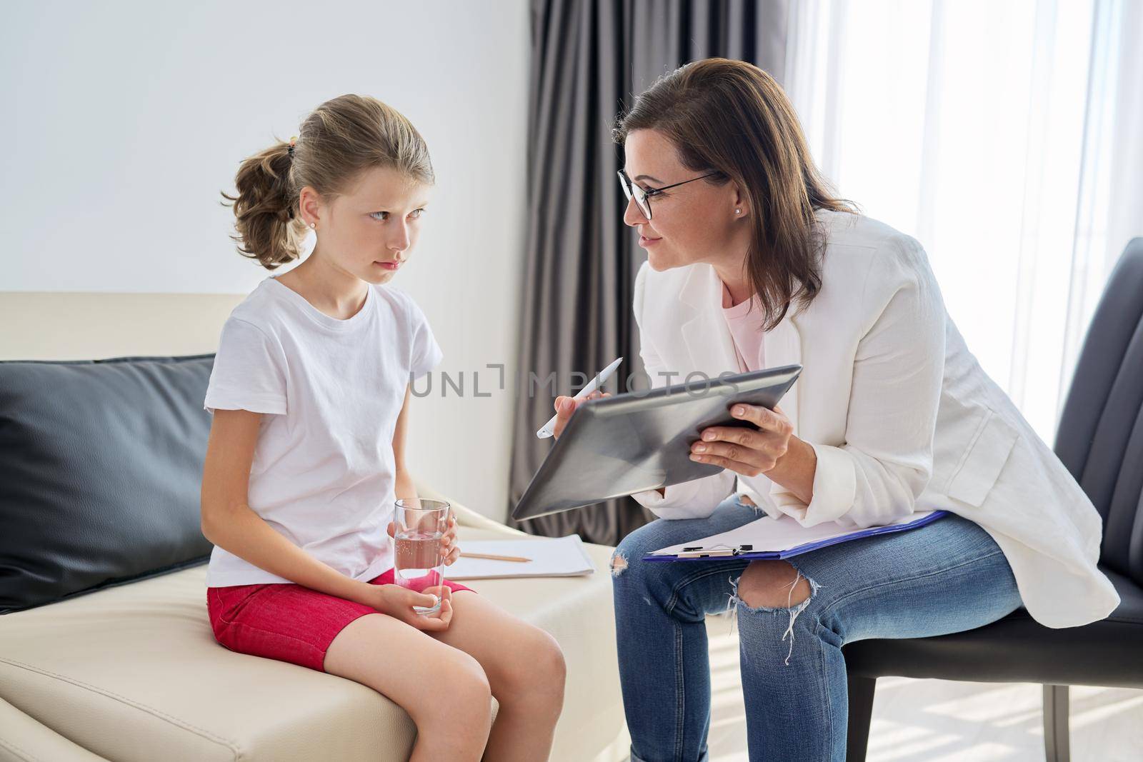 Communication session of school psychologist and girl 10, 11 years. Child tells psychotherapist his experiences, mental health of children