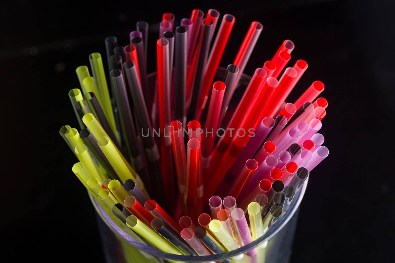 colourful bunch of straw were put in a glass cup