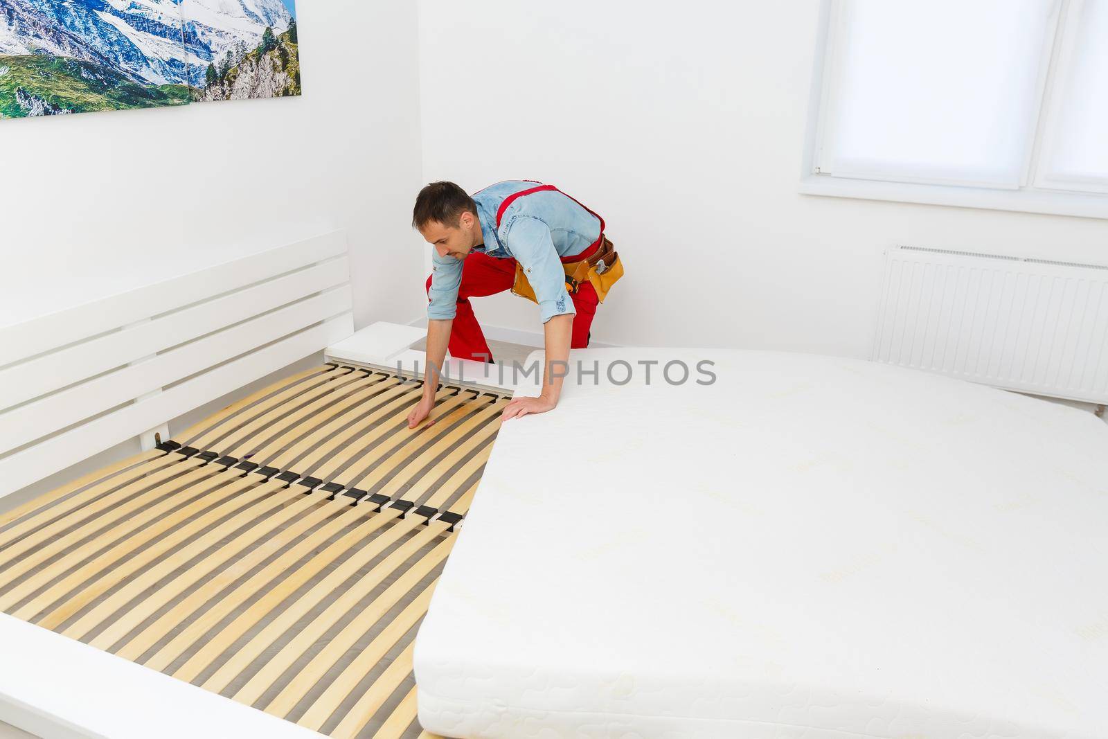 Young male contractor installing furniture at home