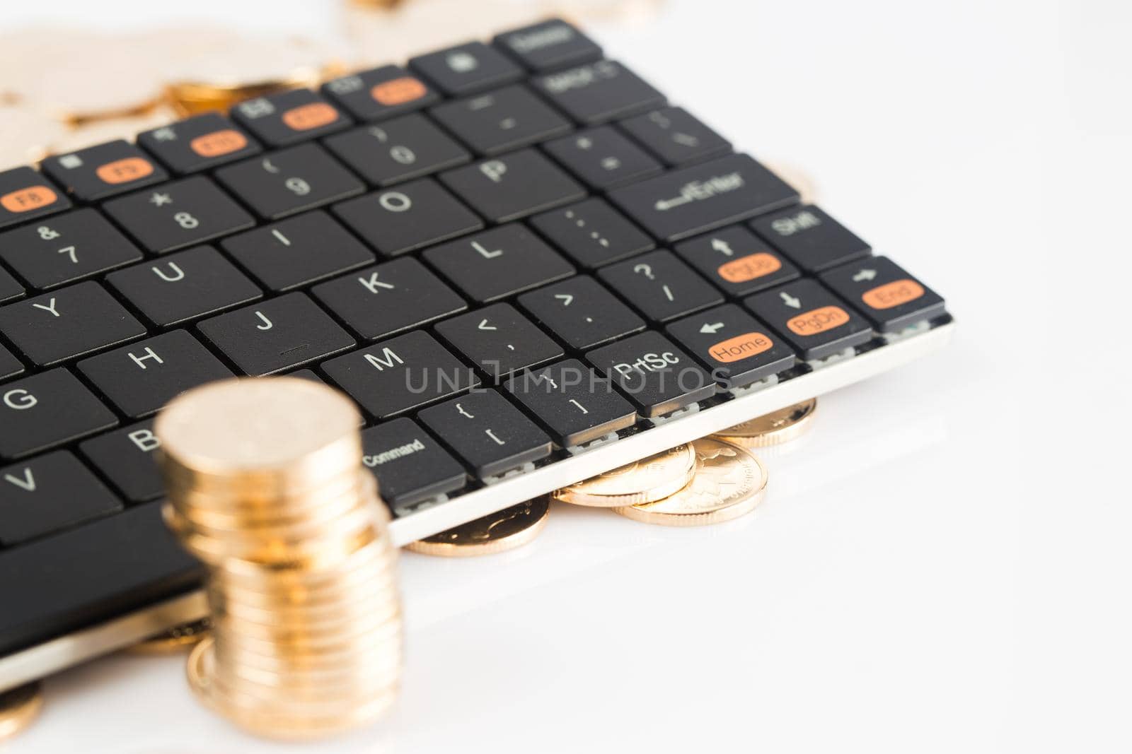 many coins and kebroad on a white background for financal contents