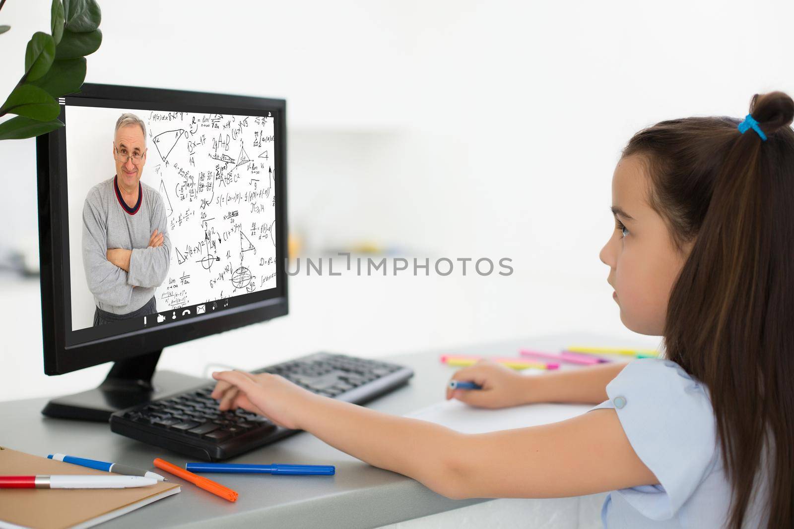 Pretty stylish schoolgirl studying homework math during her online lesson at home, social distance during quarantine, self-isolation, online education concept, home schooler