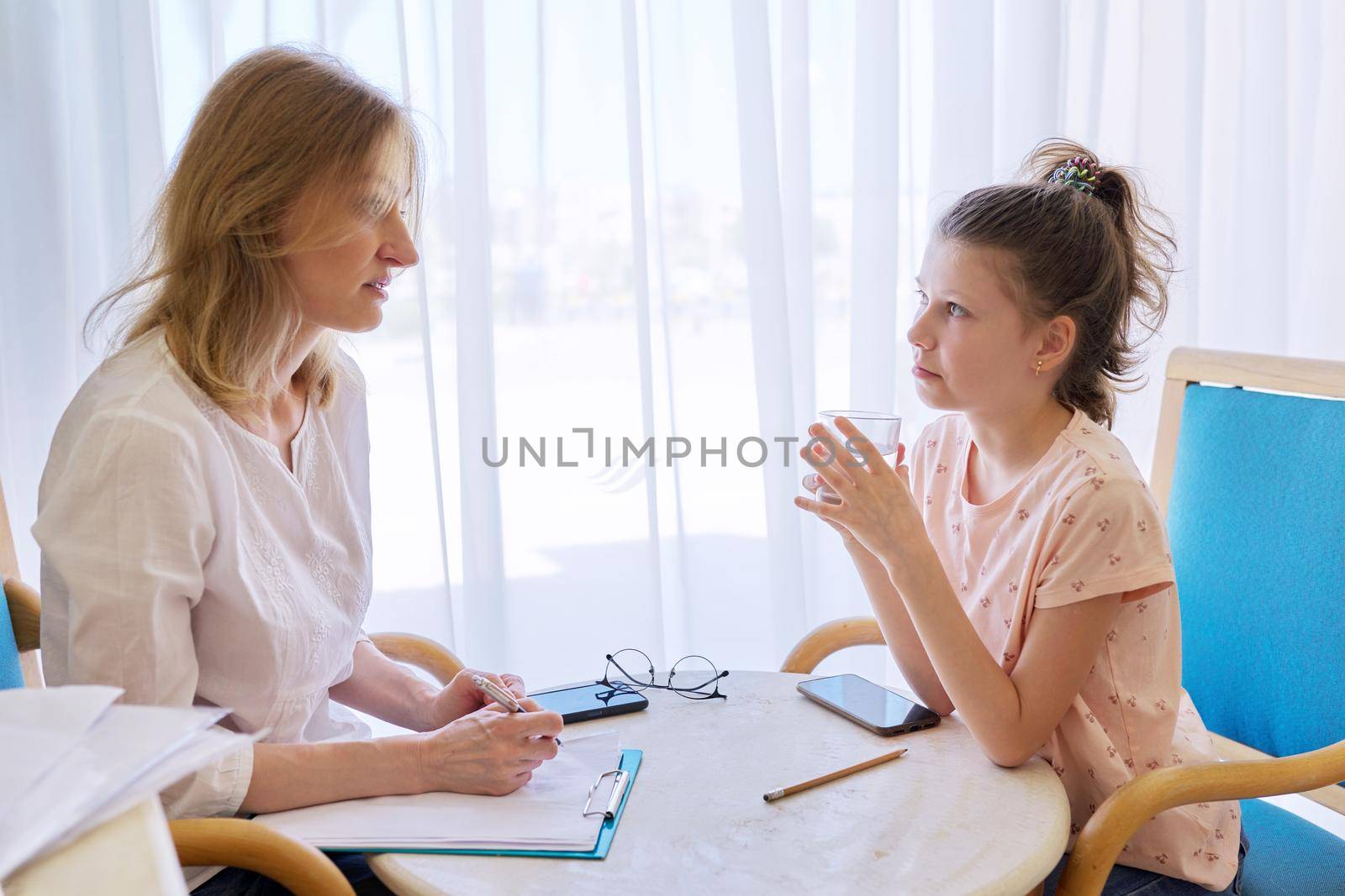 Child girl at session with social worker, school psychologist in an office. Child psychology, professional help, mental health of children, conversation between counselor and preteen girl