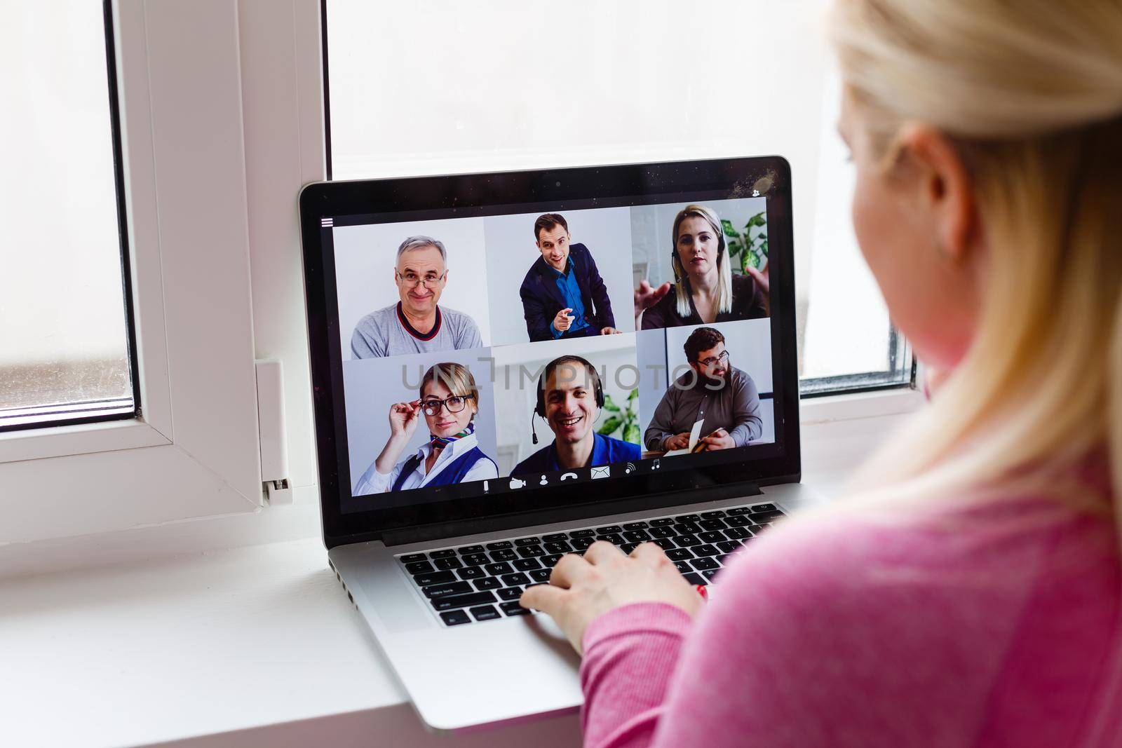 Woman Working From Home Having Group Videoconference On Laptop by Andelov13