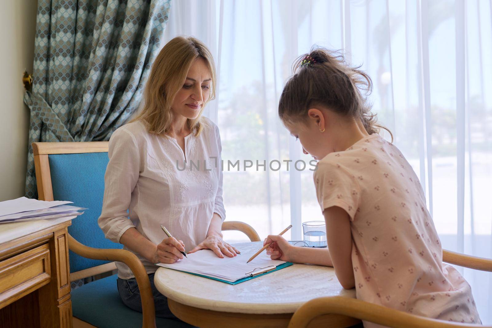 Child girl at session with social worker, school psychologist in an office. Child psychology, professional help, mental health of children, conversation between counselor and preteen girl