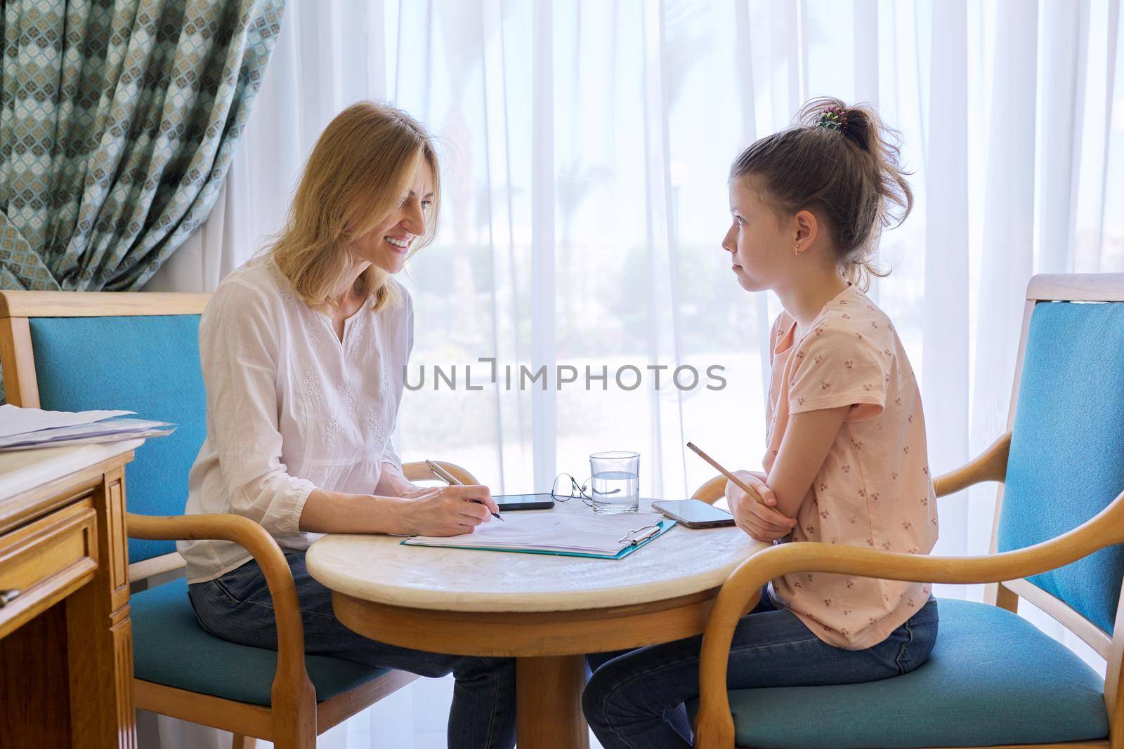 Child girl at session with social worker, school psychologist in an office. Child psychology, professional help, mental health of children, conversation between counselor and preteen girl