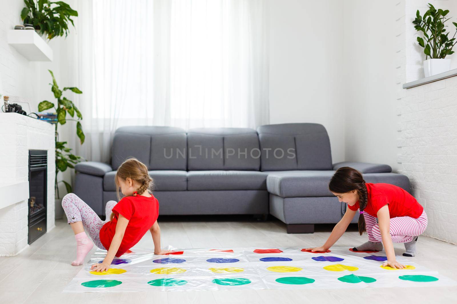 two little girls Having Fun Playing Game On Floor At Home. Siblings Friendship by Andelov13
