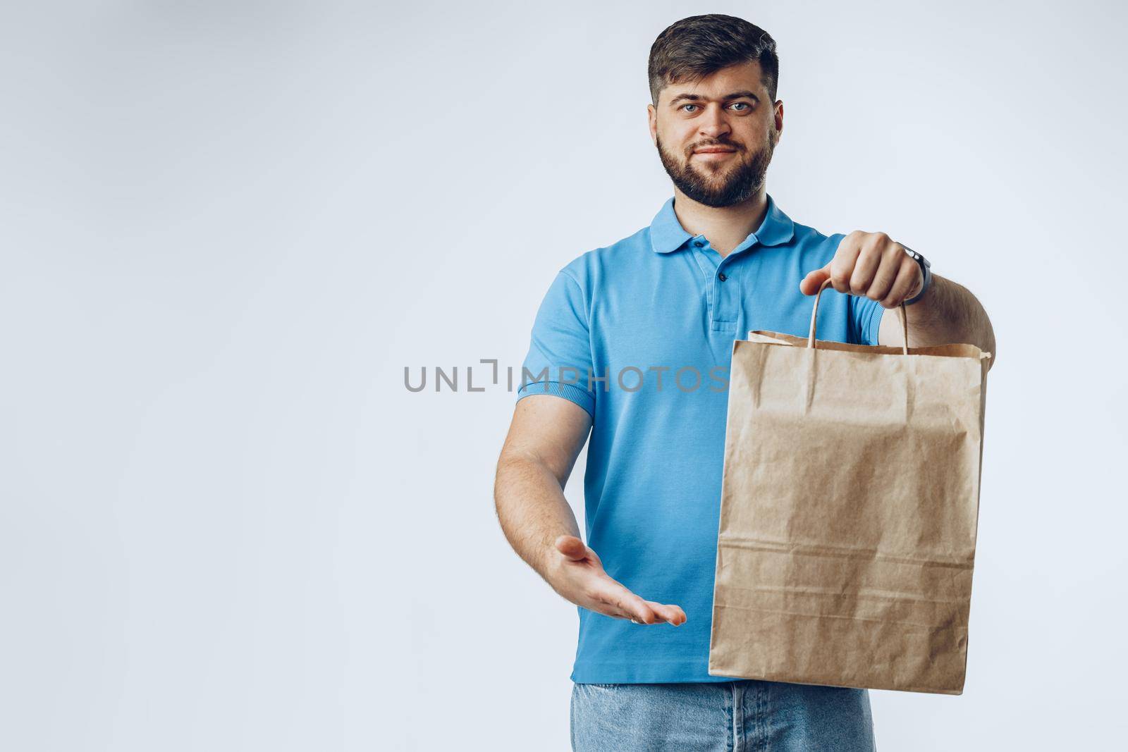 Food delivery courier with order on light grey background