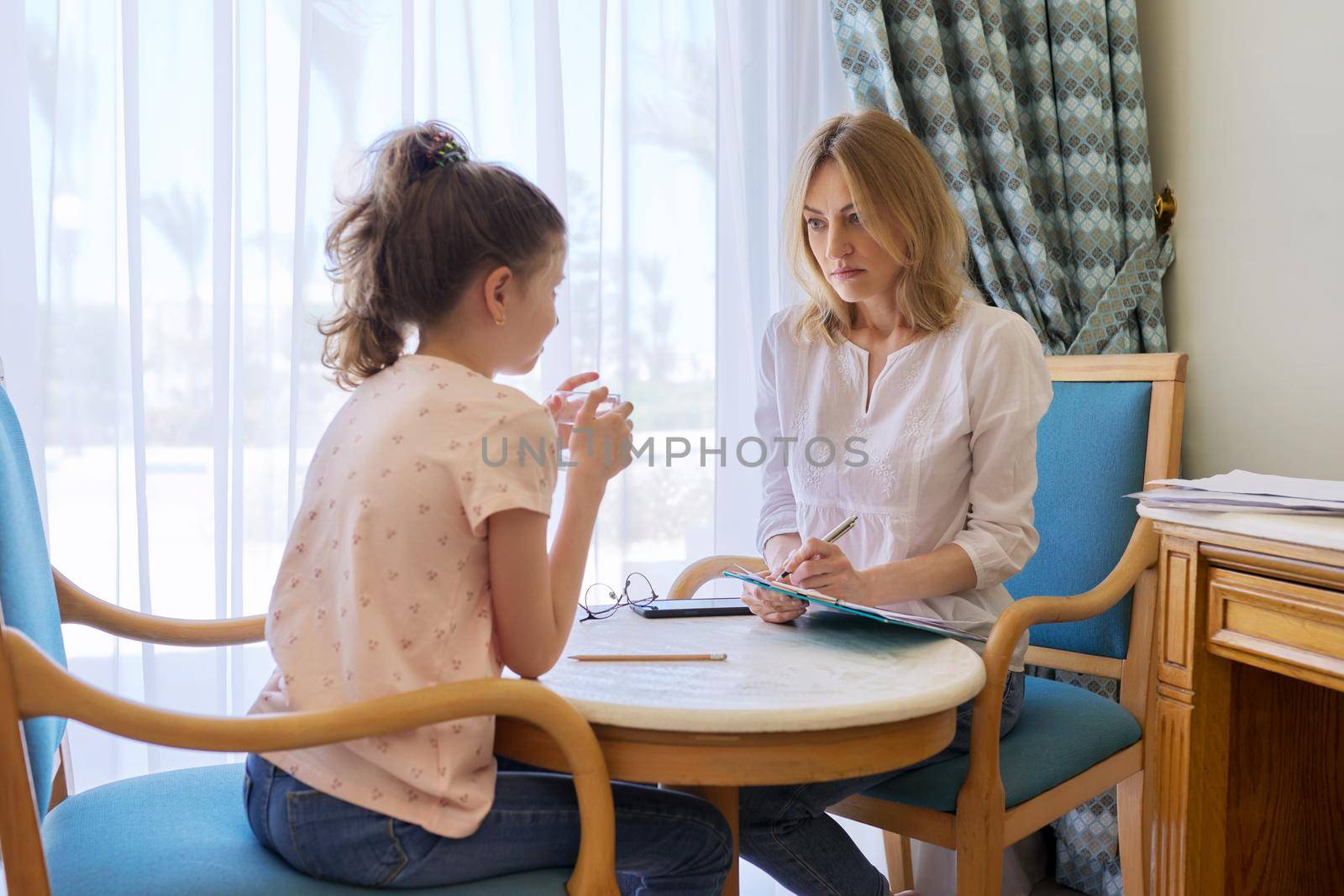 Child girl at session with social worker, school psychologist in an office. Child psychology, professional help, mental health of children, conversation between counselor and preteen girl