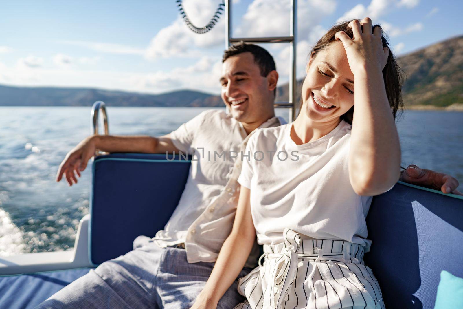 Happy couple in love on a yacht in summer on romantic vacation