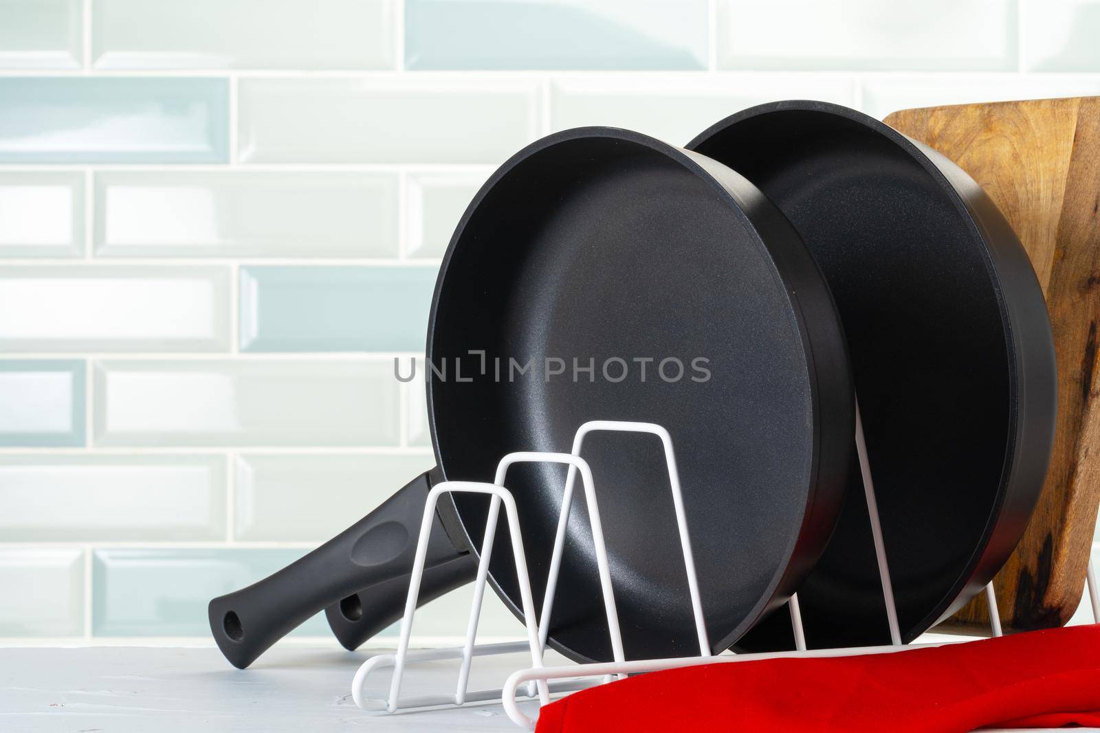 Clean and dry cooking pans on a kitchen counter. Close up.