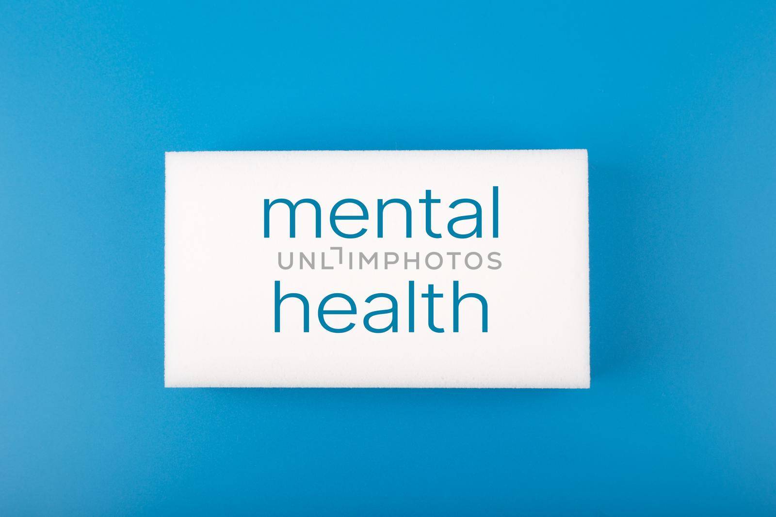 Minimal simple flat lay with white rectangle with written mental health text on dark blue blue background. Concept of world mental health day, mental health assessment and awareness