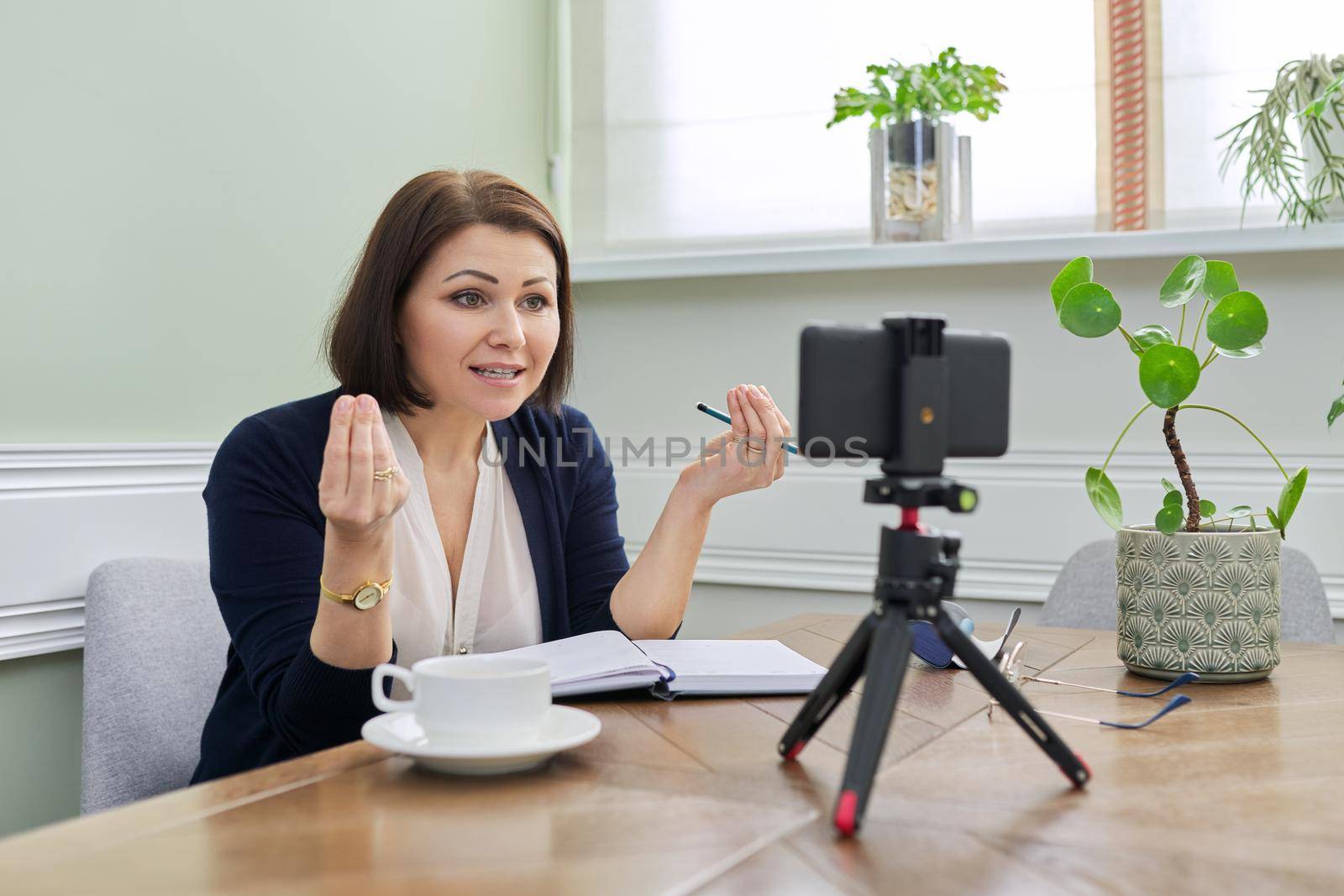 Woman teacher, business, psychologist, blogger, lawyer talking online using smartphone by VH-studio