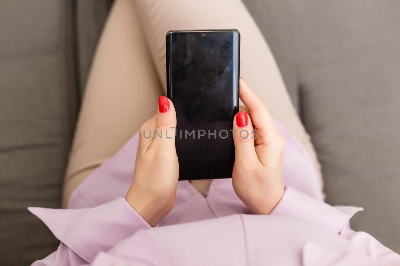 beautiful young woman using an application to send an sms message in her smartphone device while eating a salad