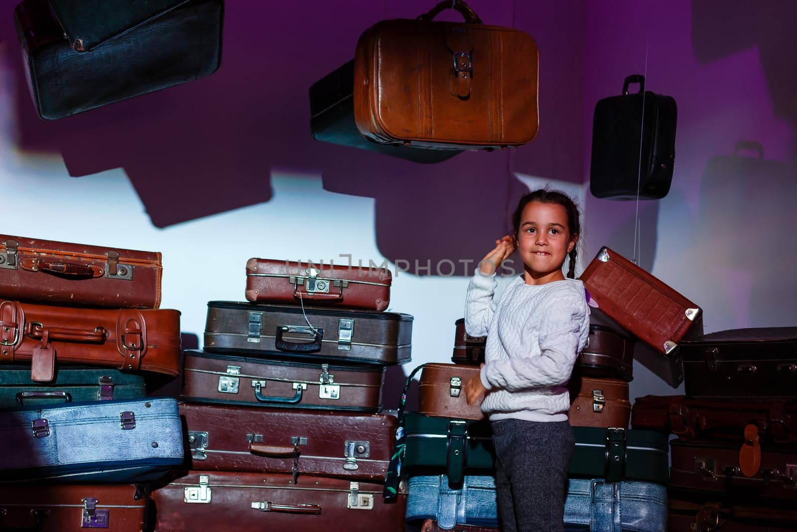 The little girl with old retro suitcases