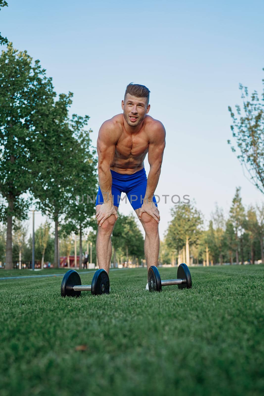 sporty man in park exercise crossfit workout. High quality photo