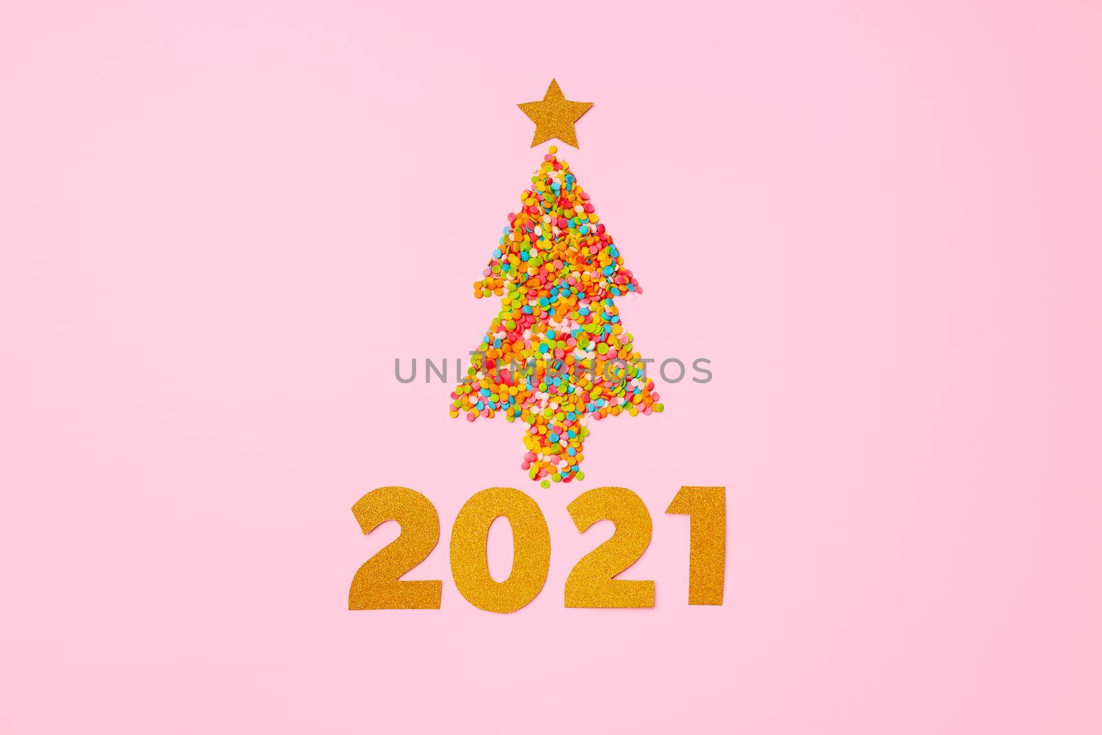 Christmas tree made of colorful confetti flat lay top view