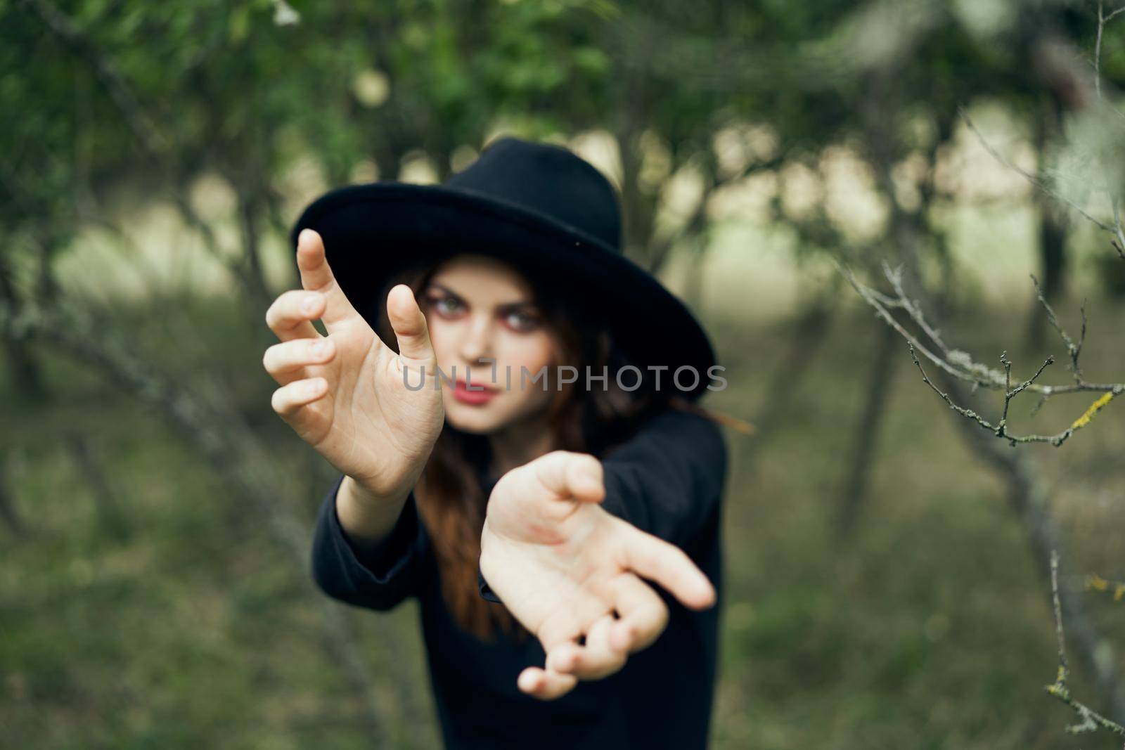 woman in a black hat gesturing with her hands witch magic fantasy by Vichizh