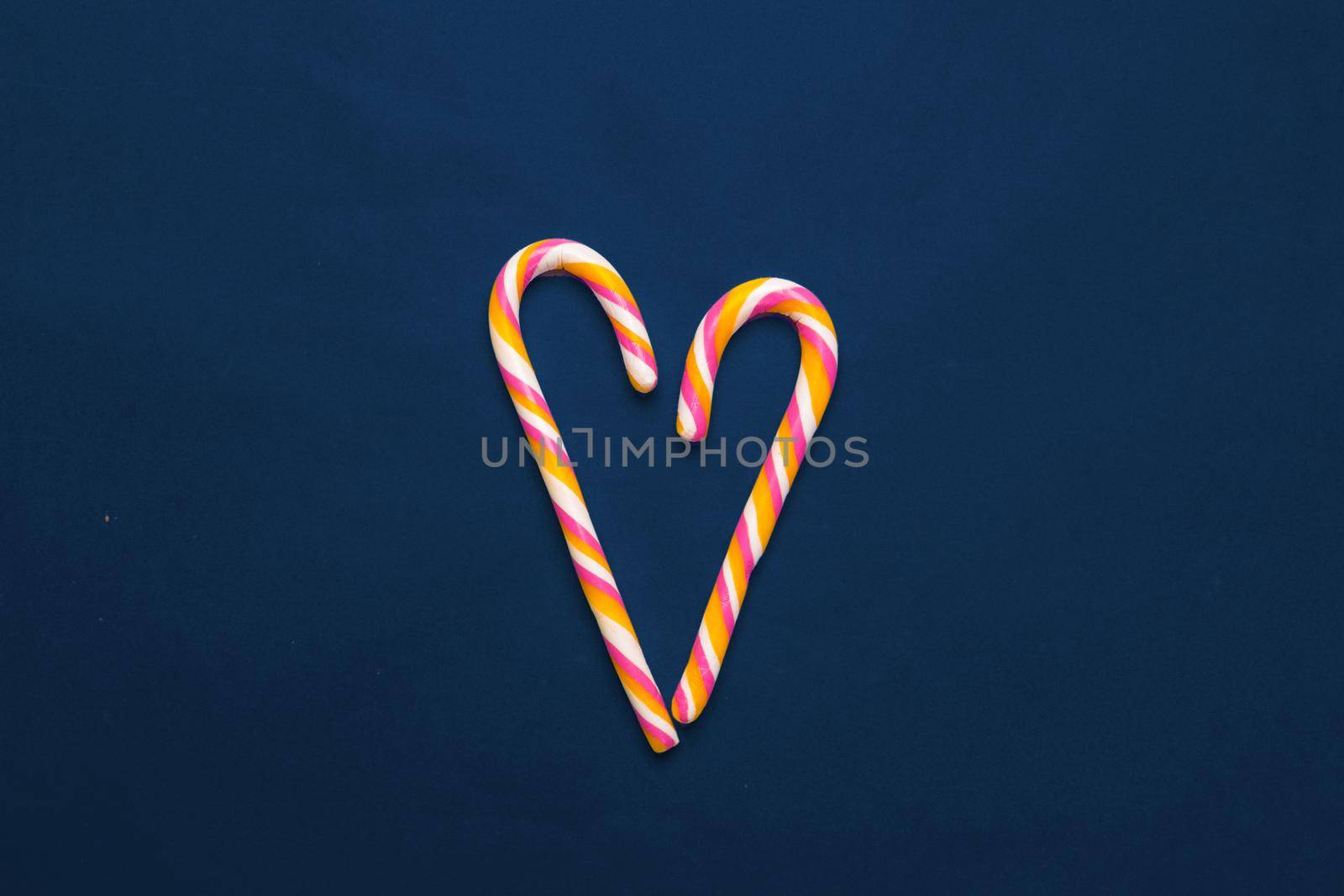 Colorful candies on table on blue background. Close up.