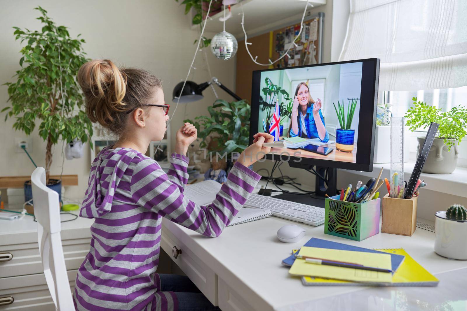 Online learning, children, little student girl learning language remotely with an English teacher. E-education, modern technologies in education, school concept