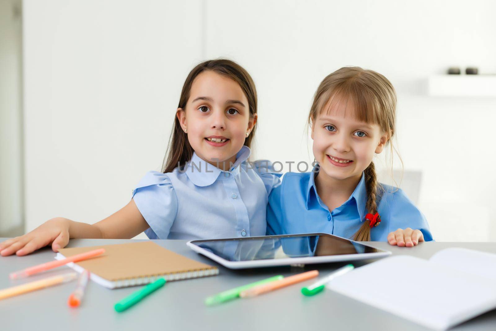 Pretty stylish schoolgirls studying during her online lesson at home, social distance during quarantine, self-isolation, online education concept