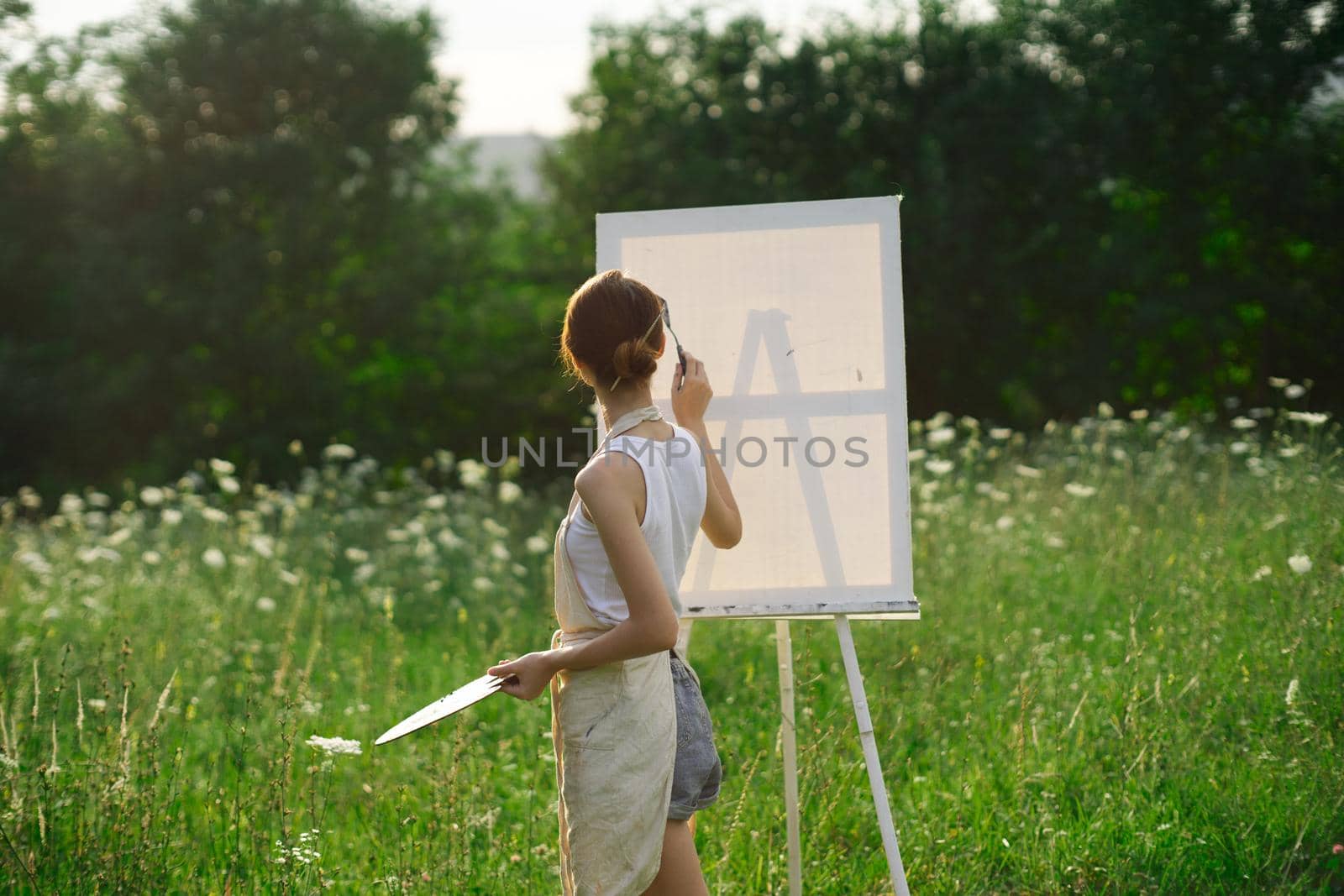 woman artist nature drawing art creative picnic. High quality photo