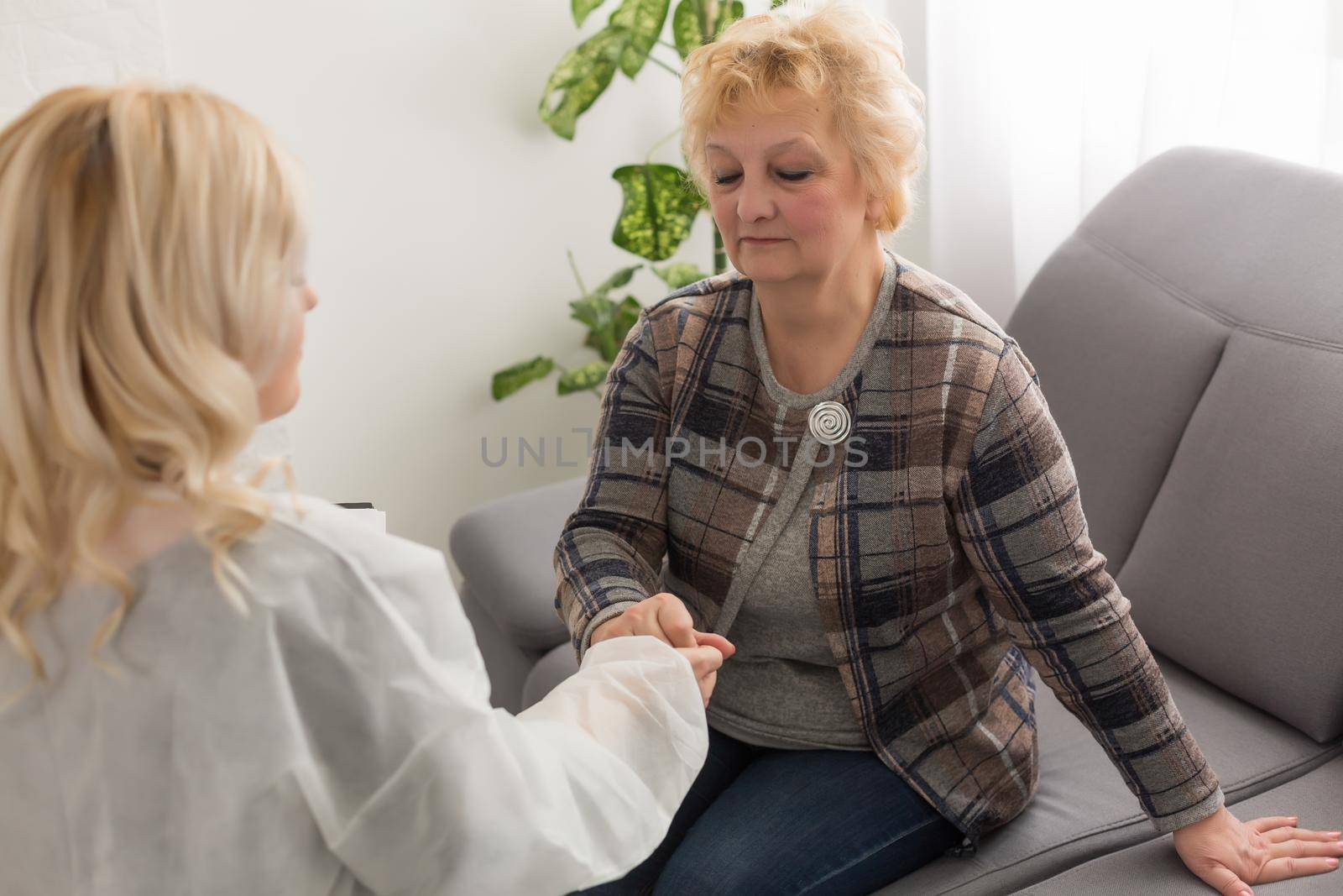 Senior woman with her home caregiver