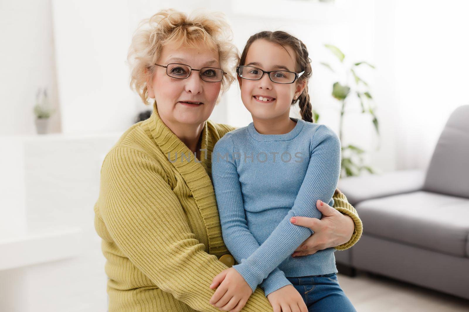 grandmother with granddaughter wearing glasses both