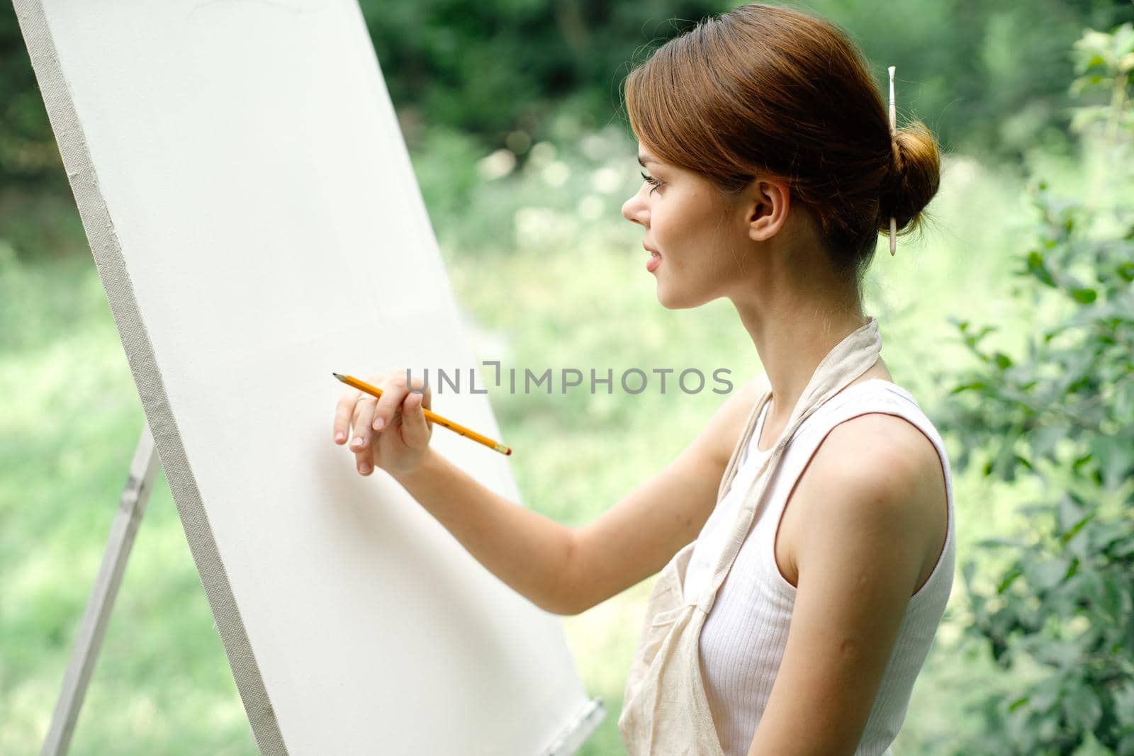 Cheerful woman artist nature easel creative art. High quality photo