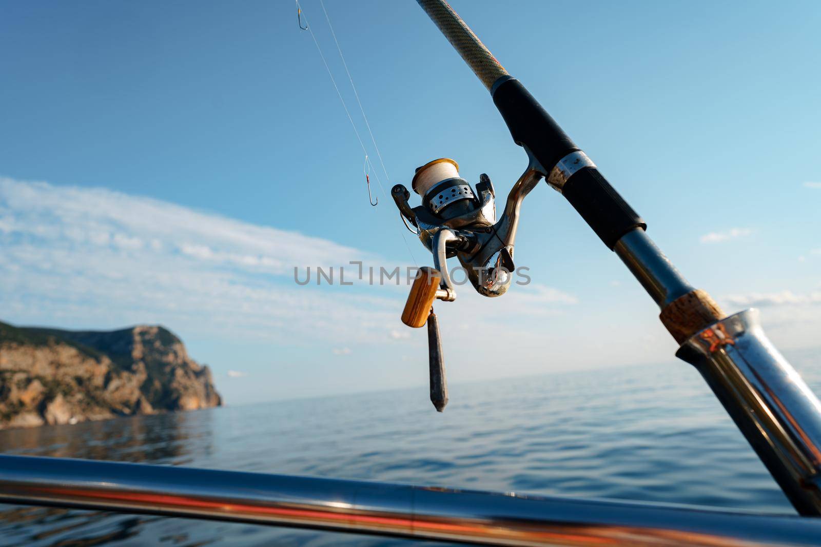 Fishing rod on a sailboat in open sea, close up photo