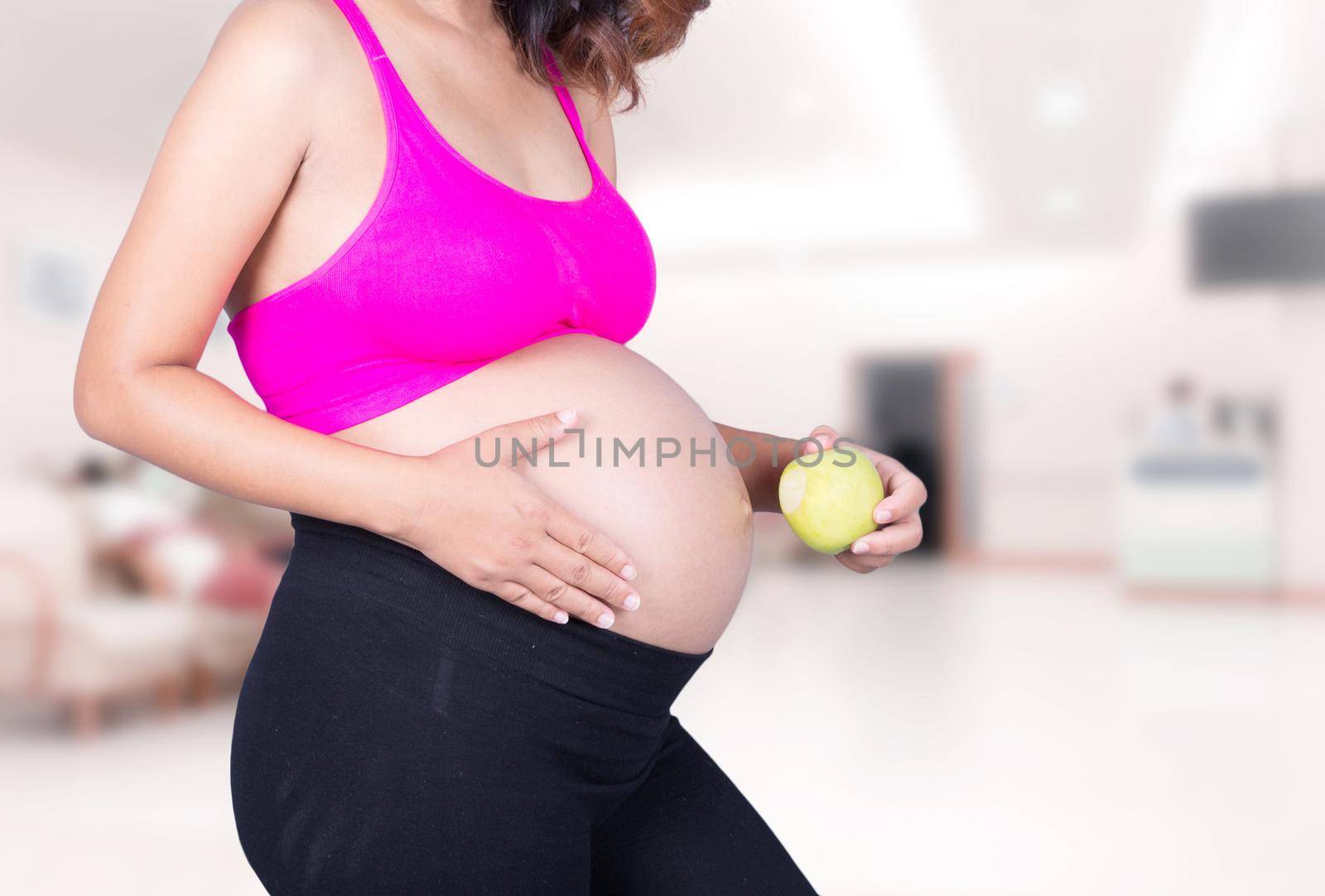 pregnant woman with green apple in hospital by geargodz