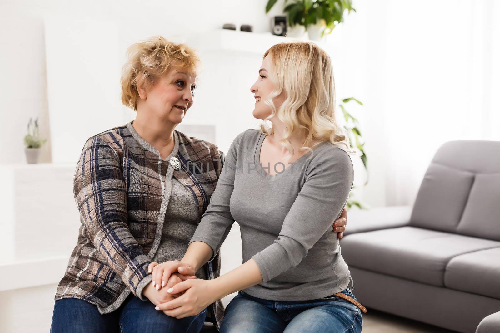 pretty woman and senior mother at home