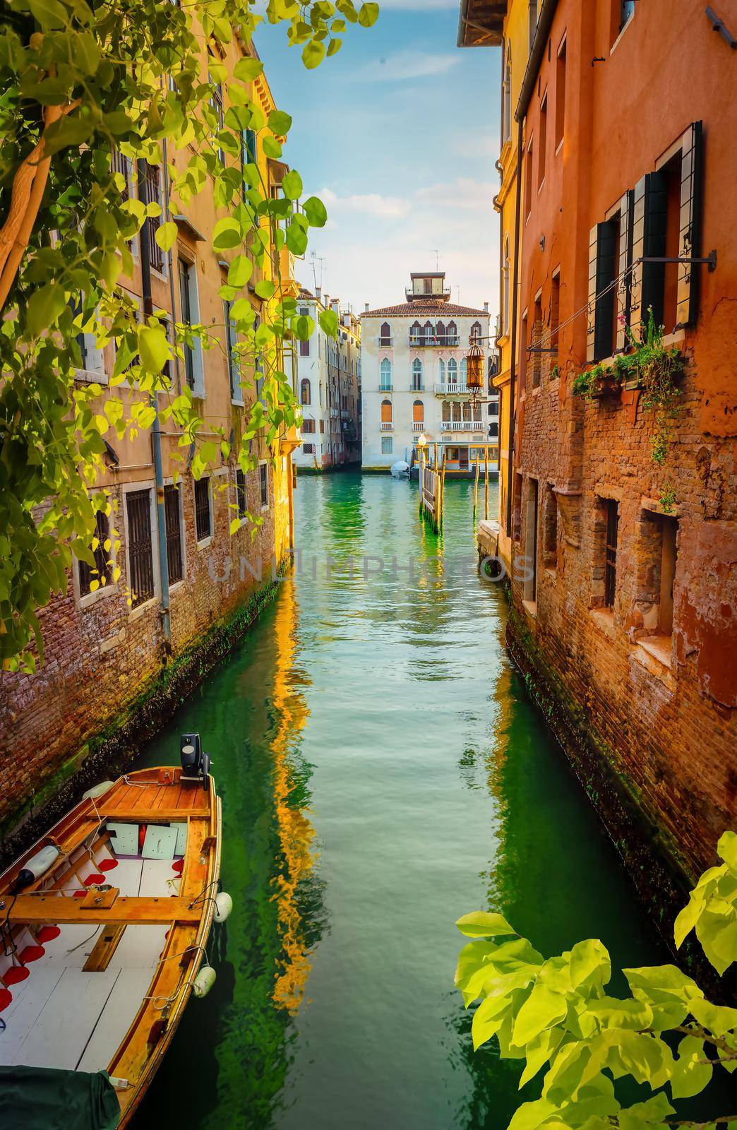 Boat in narrow venetian water canal, Italy