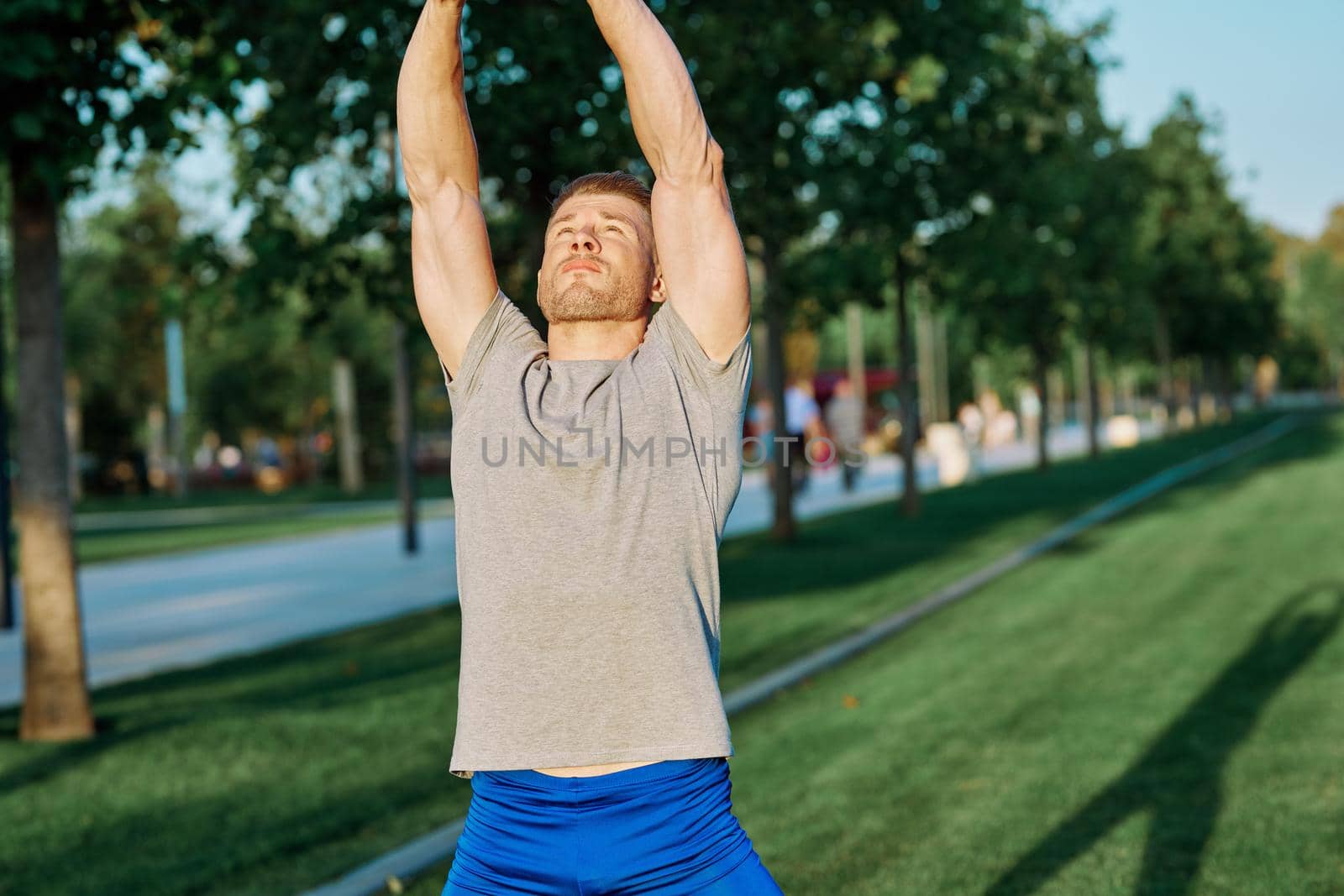athletic man in the park workout jogging exercise summer. High quality photo