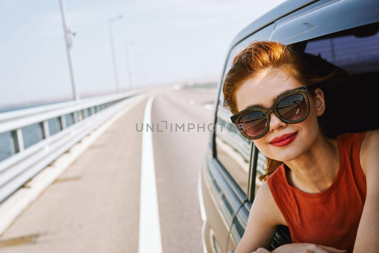 woman looking out of car window wearing sunglasses travel lifestyle by Vichizh