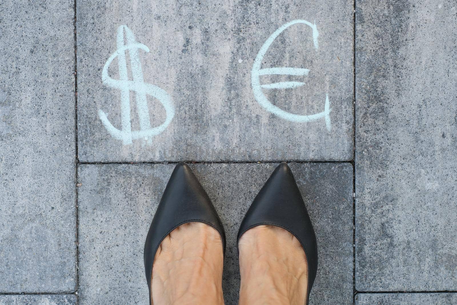 Businesswoman chooses euro or dollar signs.