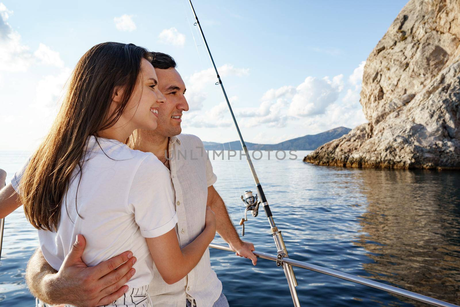 Happy couple in love on a yacht in summer on romantic vacation