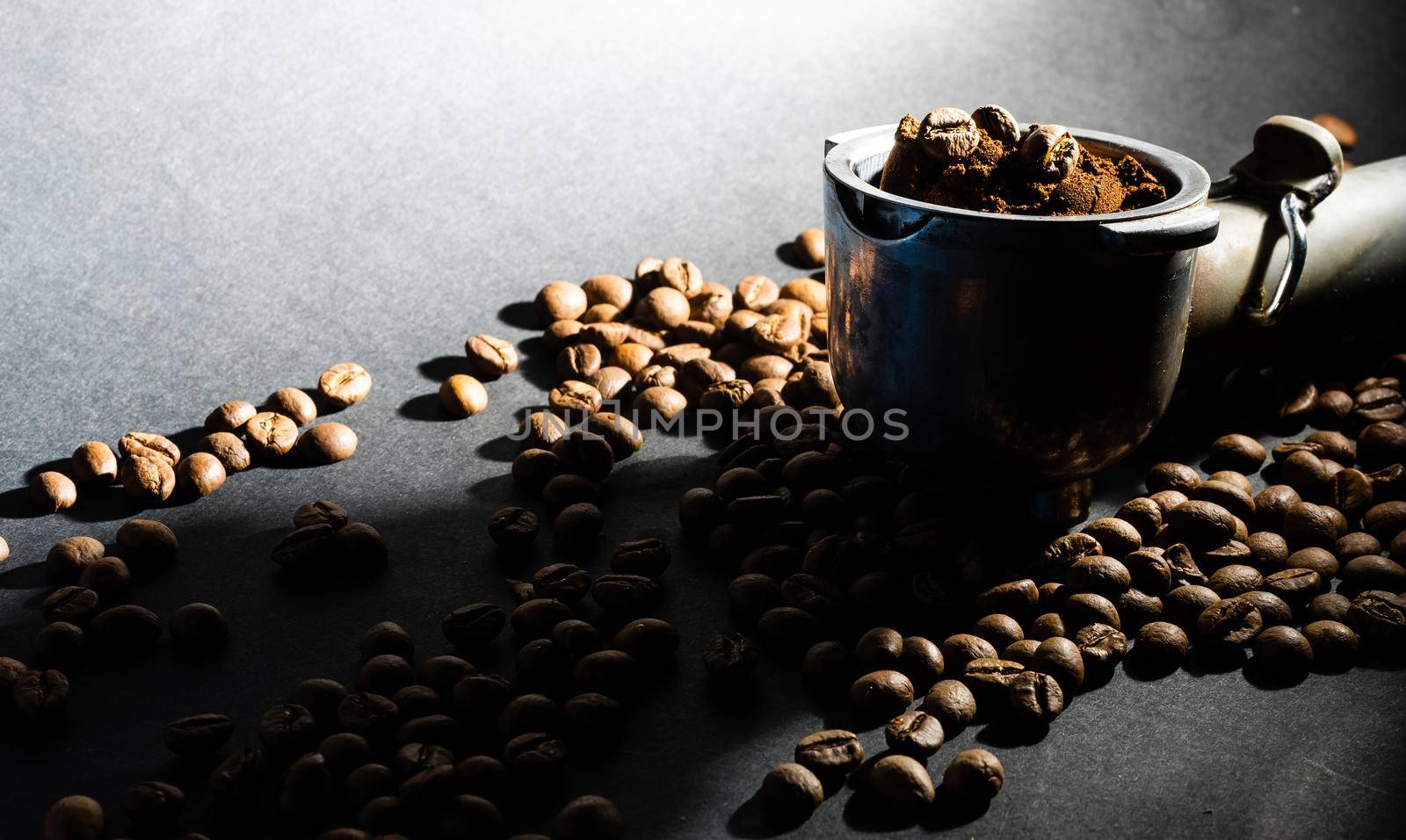 Coffee beans in the coffee horn on the background of coffee beans.