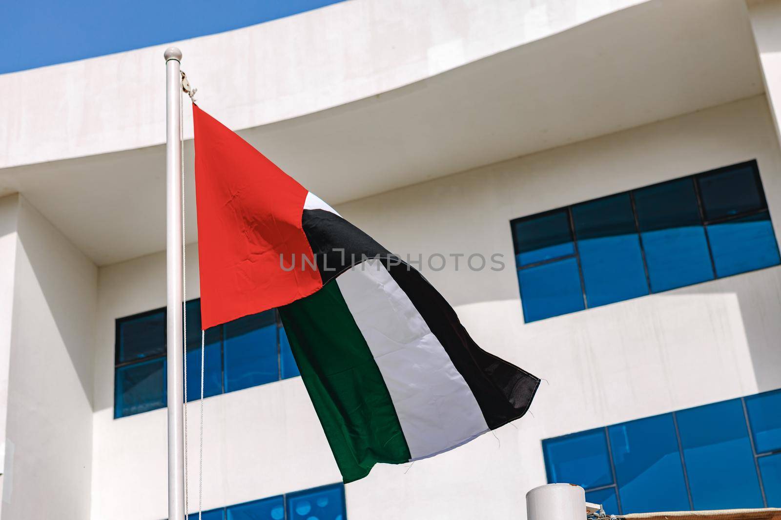 A United Arab Emirates flag flying in the wind, close up