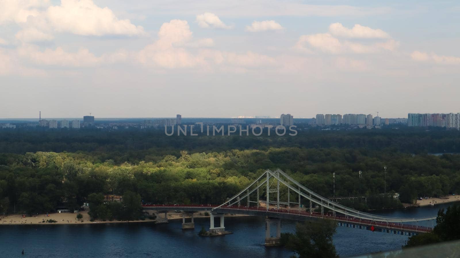 Top view of the old historical part of the city of Kiev. Vozdvizhenka area on Podol and the Dnieper river from the pedestrian bridge. Beautiful city landscape. Ukraine, Kiev - September 6, 2020
