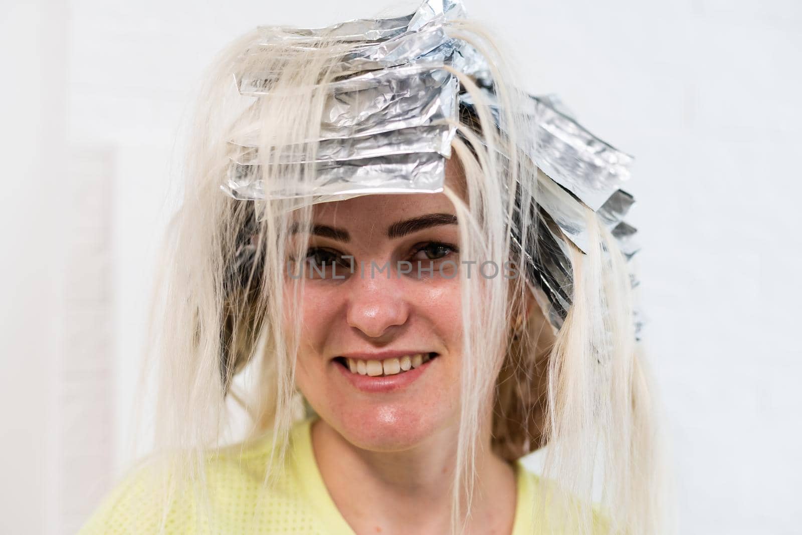 women having hair foiled in a beauty salon.