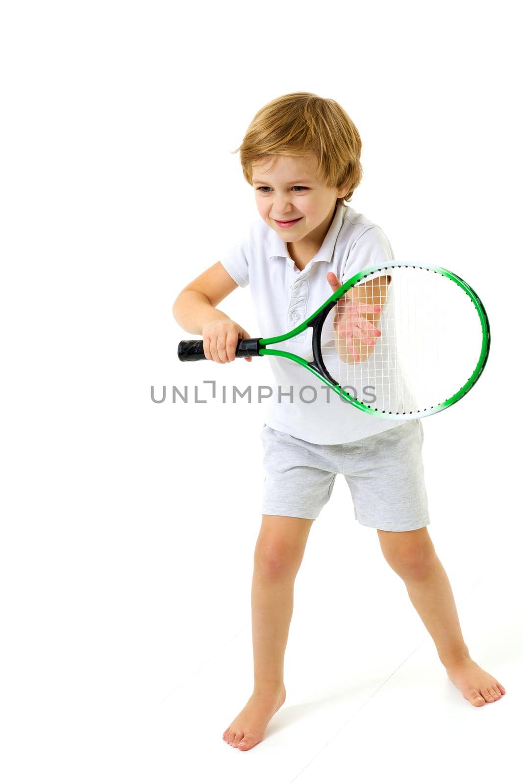 Cute little boy playing tennis. Studio portrait. by kolesnikov_studio