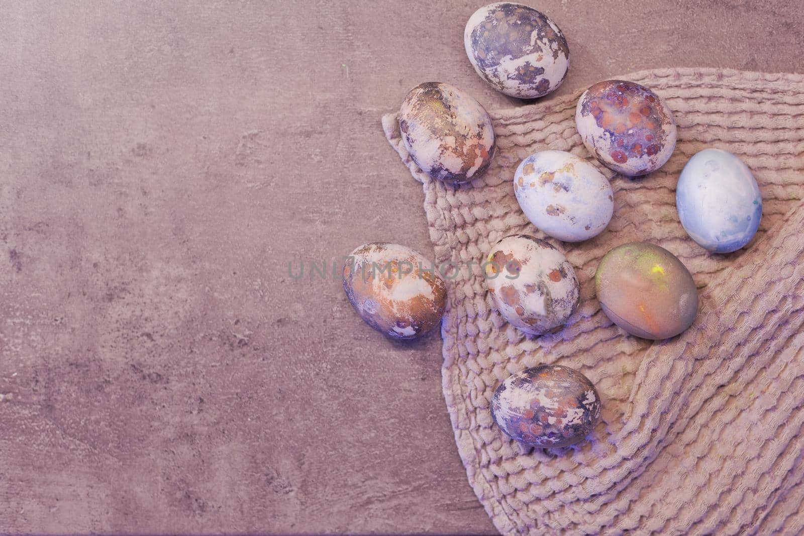 Happy Easter. Series of eggs with marble stone effect painted with natural grey concrete background with blank space for text. top view, flat lay