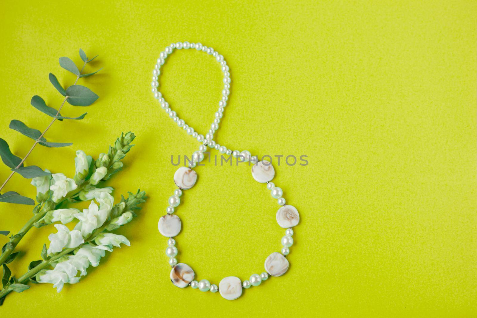 shape figure of eight 8 number on greenish paper background with white flowers. International Women's Day card. womans independence day - spring floral concept